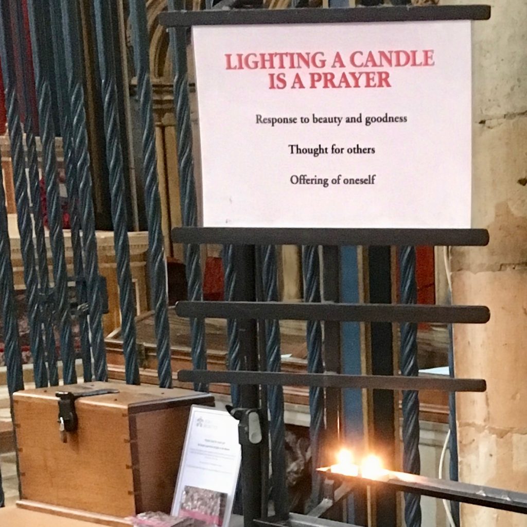 "Lighting a Candle Is A Prayer", sign in York Minster, England.
