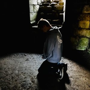 Youth praying, Finchale Priory