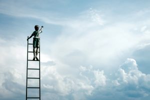 Boy reaching for the sky. Photo by Samuel Zeller on Unsplash