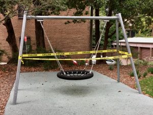 Swing set with caution tape around it