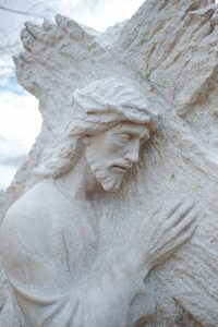 A statue of Christ carrying the cross: Photo by Wesley Tingey on Unsplash