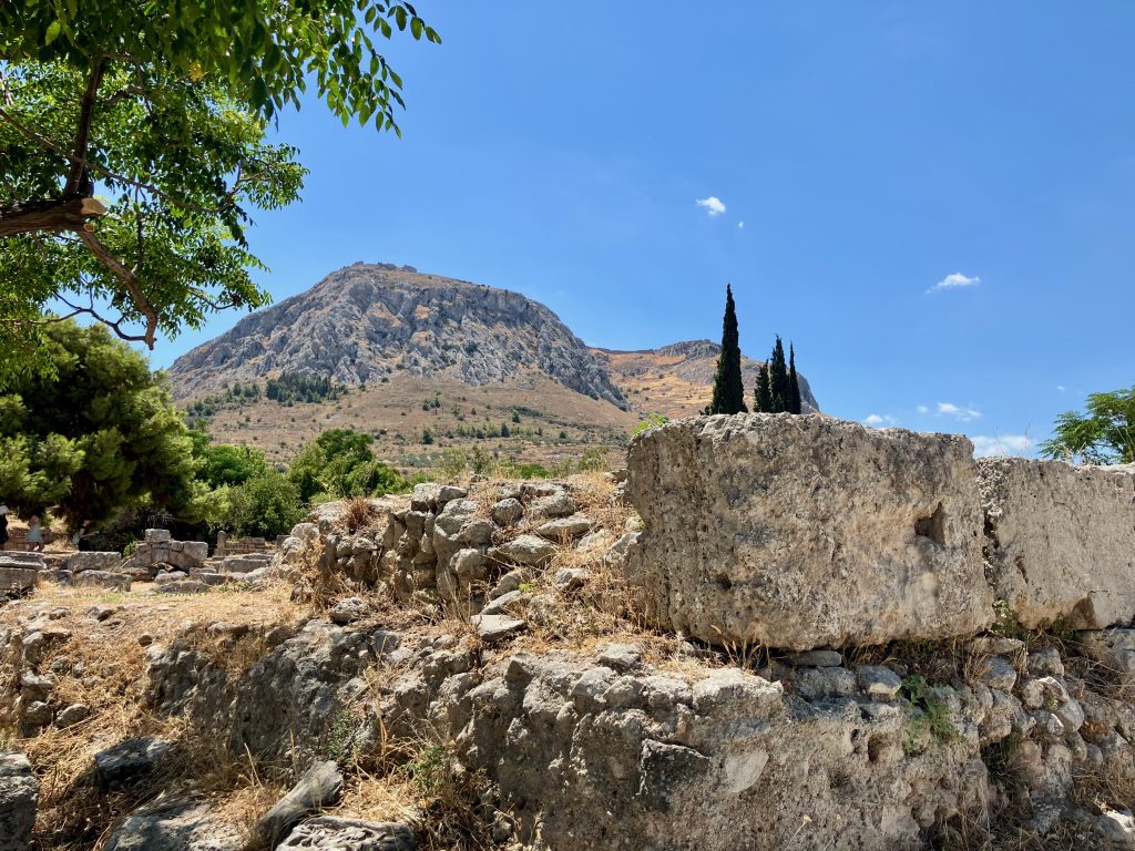 Ancient Corinth Roman Marketplace. Central Altar for public sacrifices (Acrocorinth behind)