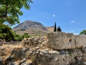 Ancient Corinth Roman Marketplace. Central Altar for public sacrifices (Acrocorinth behind)